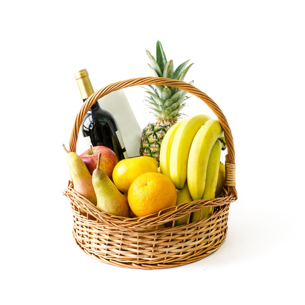 Basket of fruits and a bottle of imported red wine