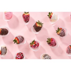Strawberries coated with black, white and pink chocolates.