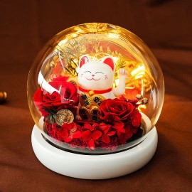 Fleurs rouges préservées et chat porte-bonheur chinois qui bouge la patte dans un dôme de verre
