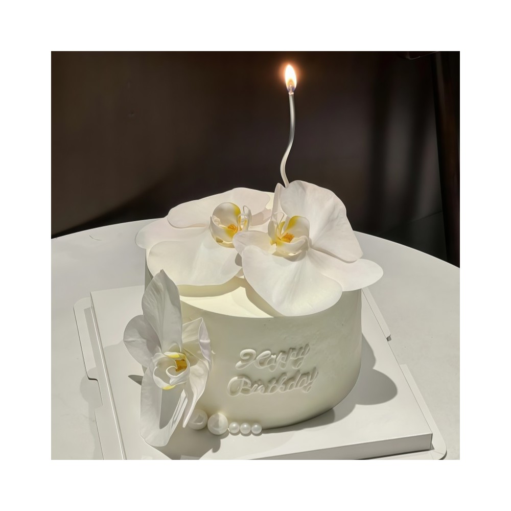 Elegant white birthday cake with white orchids