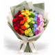 Colorful Love bouquet with rainbow-coloured flowers, green and cream wrapping, and a cream ribbon