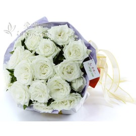 19 premium white roses in full bloom accented with fresh greens.