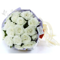 19 premium white roses in full bloom accented with fresh greens.