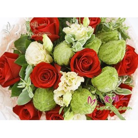 Bouquet composed of 11 blooming red roses, champagne lisianthus, club fruits, euphorbia marginata and fresh greens.
