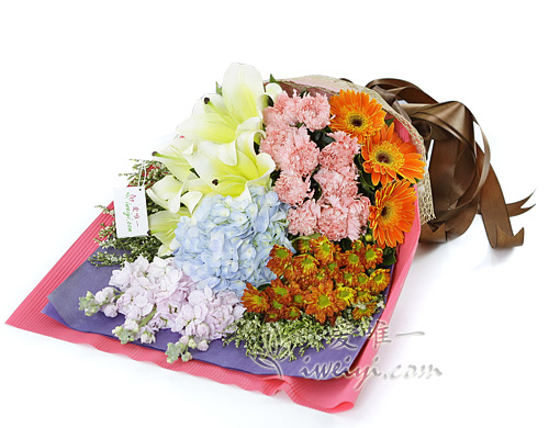 bouquet of yellow perfume lilies and pink carnations