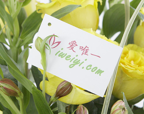 vase of flowers with yellow roses