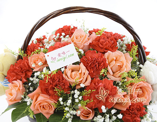 basket of pink roses and red carnations